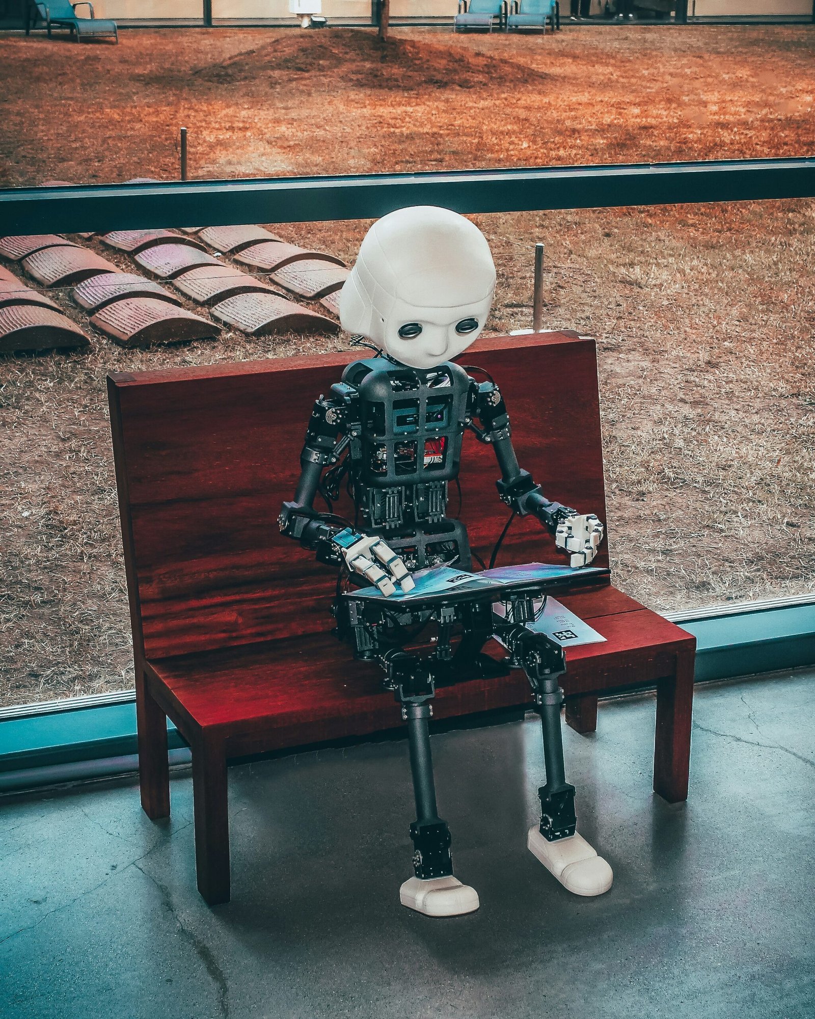 black and white robot toy on red wooden table